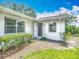 Exterior entrance to the home with a decorative garden and landscaped yard at 2014 Hampstead Cir, Sun City Center, FL 33573