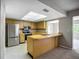 Well-lit kitchen with stainless steel appliances and ample counter space at 2014 Hampstead Cir, Sun City Center, FL 33573