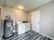 Laundry room features wood plank flooring and a washer and dryer at 2014 Hampstead Cir, Sun City Center, FL 33573