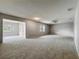 Spacious living room featuring neutral paint, plush carpet, and an airy open floorplan at 2014 Hampstead Cir, Sun City Center, FL 33573
