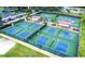 Community pickleball courts with shade structures, lush greenery, and nearby parking at 2014 Hampstead Cir, Sun City Center, FL 33573