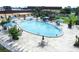 Large community outdoor pool with plenty of seating for lounging and relaxation at 2014 Hampstead Cir, Sun City Center, FL 33573