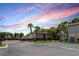 Exterior view of the apartment building with trees, sidewalk and reserved parking space at 213 Red Cedar Pl # 213, Brandon, FL 33510