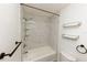 Bathroom with a shower-tub combo, modern tile, and open shelving at 213 Red Cedar Pl # 213, Brandon, FL 33510