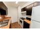 Kitchen features stainless steel sink, white appliances, and wood countertops at 213 Red Cedar Pl # 213, Brandon, FL 33510