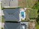 Aerial view of home and backyard featuring a pool, spa, sauna, and landscaping at 21648 Snowy Orchid Ter, Land O Lakes, FL 34637