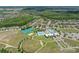 Aerial view of community amenities including pools, tennis courts, and expansive green spaces, perfect for recreation at 21648 Snowy Orchid Ter, Land O Lakes, FL 34637