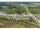 An aerial view of the property set amongst ponds and lush trees, highlighting its prime location and surroundings at 21648 Snowy Orchid Ter, Land O Lakes, FL 34637