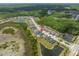 Aerial view of property situated amongst ponds and roadways, showcasing an ideal community surrounded by lush trees at 21648 Snowy Orchid Ter, Land O Lakes, FL 34637