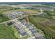 Aerial shot showcasing the property's location near schools, ponds, and roadways, highlighting its convenient setting at 21648 Snowy Orchid Ter, Land O Lakes, FL 34637