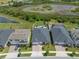 Aerial view of the property showcasing the home, driveway, lawn, and surrounding neighborhood at 21648 Snowy Orchid Ter, Land O Lakes, FL 34637