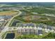 An aerial view shows the neighborhood street, surrounding trees, and nearby ponds at 21648 Snowy Orchid Ter, Land O Lakes, FL 34637