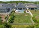 Aerial view of the backyard showing a pool, lounge seating, mature trees, and a fenced-in yard at 21648 Snowy Orchid Ter, Land O Lakes, FL 34637