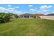 Spacious backyard featuring a well-maintained lawn, mature trees, and a private pool area at 21648 Snowy Orchid Ter, Land O Lakes, FL 34637