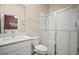 Bathroom featuring a glass enclosed shower, marble countertop vanity, and toilet at 21648 Snowy Orchid Ter, Land O Lakes, FL 34637