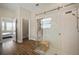 Bright bathroom showcasing a tiled shower with a glass enclosure and a linen closet at 21648 Snowy Orchid Ter, Land O Lakes, FL 34637