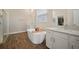 Bright bathroom showcasing a soaking tub, dual vanities, and a glass-enclosed shower at 21648 Snowy Orchid Ter, Land O Lakes, FL 34637