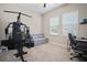 Versatile bedroom is equipped with a home gym, cozy daybed, and dedicated office space at 21648 Snowy Orchid Ter, Land O Lakes, FL 34637