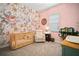 Charming Bedroom features a floral wallpaper accent wall and coordinating furniture for a cozy atmosphere at 21648 Snowy Orchid Ter, Land O Lakes, FL 34637