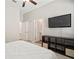 View of the Primary bedroom, featuring a television, carpet, and a ceiling fan at 21648 Snowy Orchid Ter, Land O Lakes, FL 34637