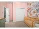 Bedroom showcases a soft floral wallpaper and includes a crib and plenty of closet space at 21648 Snowy Orchid Ter, Land O Lakes, FL 34637
