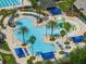 Community's expansive pool area showcasing a variety of seating options, water features, and lush landscaping at 21648 Snowy Orchid Ter, Land O Lakes, FL 34637