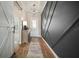 Inviting entryway with decorative wall trim, modern light fixture, and wood-look flooring at 21648 Snowy Orchid Ter, Land O Lakes, FL 34637