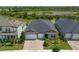 Aerial view of a charming home with a well-manicured lawn and a brick driveway at 21648 Snowy Orchid Ter, Land O Lakes, FL 34637