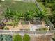 Aerial view of a well-maintained garden with raised beds, gravel paths, and a wooden fence at 21648 Snowy Orchid Ter, Land O Lakes, FL 34637