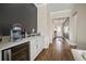 Stylish hallway featuring a built-in bar with white cabinets and a wine refrigerator at 21648 Snowy Orchid Ter, Land O Lakes, FL 34637