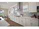 Updated kitchen with stainless appliances, quartz counters, and gas cooktop with backsplash at 21648 Snowy Orchid Ter, Land O Lakes, FL 34637