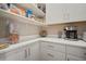 Pantry area features quartz countertops, white cabinets, and room for small appliances and storage at 21648 Snowy Orchid Ter, Land O Lakes, FL 34637
