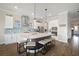Spacious kitchen with quartz counters, stainless appliances, kitchen island with barstool seating, and wood floors at 21648 Snowy Orchid Ter, Land O Lakes, FL 34637