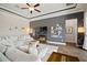 Comfortable living room featuring a large sectional sofa, TV, and stylish decor at 21648 Snowy Orchid Ter, Land O Lakes, FL 34637