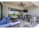 Outdoor patio featuring a ceiling fan, TV, outdoor kitchen, and seamless indoor-outdoor living at 21648 Snowy Orchid Ter, Land O Lakes, FL 34637