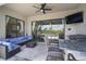 Outdoor patio featuring a ceiling fan, outdoor kitchen, and outdoor seating with a view at 21648 Snowy Orchid Ter, Land O Lakes, FL 34637