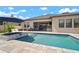 Beautiful backyard pool and spa with patio and outdoor seating, perfect for entertaining and relaxation at 21648 Snowy Orchid Ter, Land O Lakes, FL 34637
