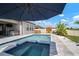 Backyard features a pool, spa, outdoor kitchen, and sauna for ultimate relaxation and entertainment at 21648 Snowy Orchid Ter, Land O Lakes, FL 34637