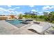 Backyard pool with spa and sauna amidst beautifully landscaped surroundings at 21648 Snowy Orchid Ter, Land O Lakes, FL 34637