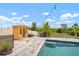Backyard oasis featuring a pool, sauna, lounge seating, and a lush, landscaped yard at 21648 Snowy Orchid Ter, Land O Lakes, FL 34637