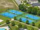Aerial view of the community's blue and green tennis courts, offering recreational options at 21648 Snowy Orchid Ter, Land O Lakes, FL 34637