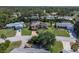 Picturesque aerial view of a residential neighborhood surrounded by lush trees and a golf course at 2287 Demaret Dr, Dunedin, FL 34698