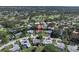 Neighborhood aerial view of a home on a golf course with mature trees and well-maintained landscaping at 2287 Demaret Dr, Dunedin, FL 34698