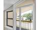 View from balcony provides natural light and a glimpse of the neighborhood and street below at 2287 Demaret Dr, Dunedin, FL 34698