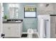 Stylish bathroom with a sleek vanity, modern fixtures, and walk-in shower at 2287 Demaret Dr, Dunedin, FL 34698