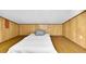 A simple bedroom with paneled walls and an unadorned bed provides a minimalist sleeping space at 2287 Demaret Dr, Dunedin, FL 34698