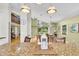 Open-concept dining room with modern decor, hardwood floors, and lots of light at 2287 Demaret Dr, Dunedin, FL 34698