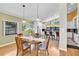 Open concept dining area with hardwood floors, pendant lighting, and adjoins the kitchen with bar seating at 2287 Demaret Dr, Dunedin, FL 34698