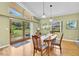 Bright dining room features wood floors, sliding glass doors to the backyard, and pendant lighting at 2287 Demaret Dr, Dunedin, FL 34698