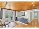 Inviting entryway with a wood-paneled ceiling, tiled floors, and a charming chair beside the door at 2287 Demaret Dr, Dunedin, FL 34698